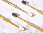 LaserGlow luxury gold and silver soft bristle toothbrush for gentle and effective cleaning.